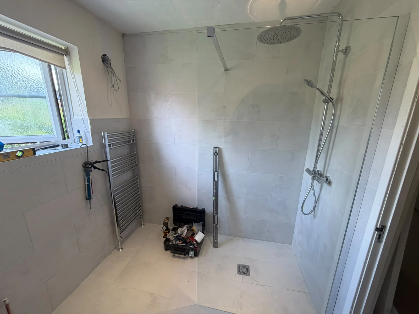 Walk-in shower with rainfall head and large grey wall tiles — RV Renovation, Oxford